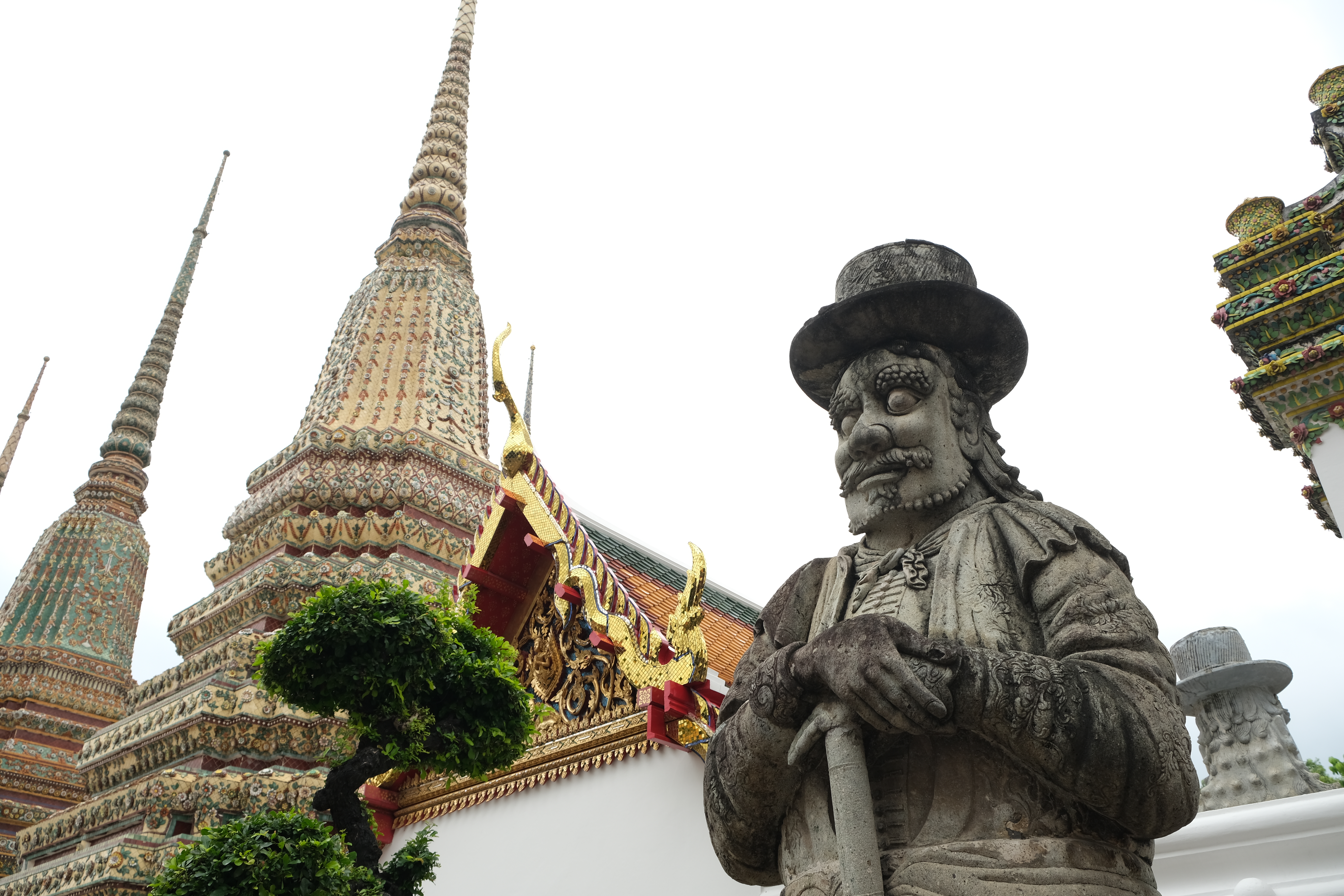 huge chiseled statues decorating the gates and doors of the temple Wat Pho Bangkok Thailand